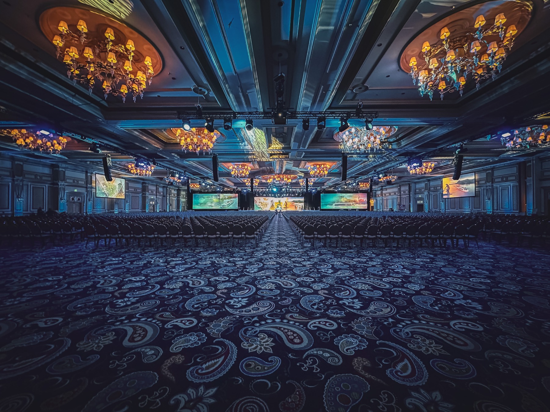 Large-scale general session with massive LED screens and chandeliers