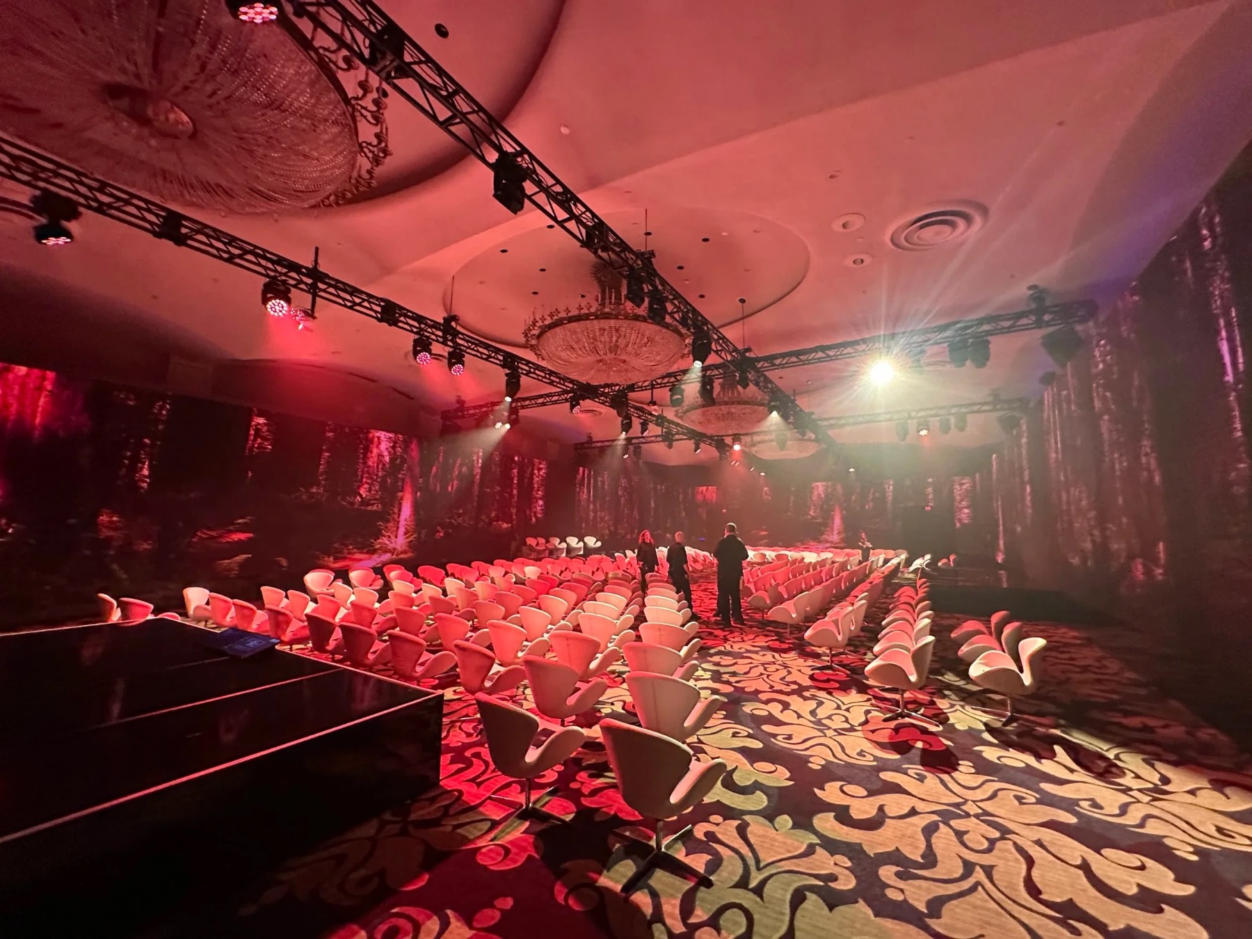 Immersive forest-projection room with swan chairs