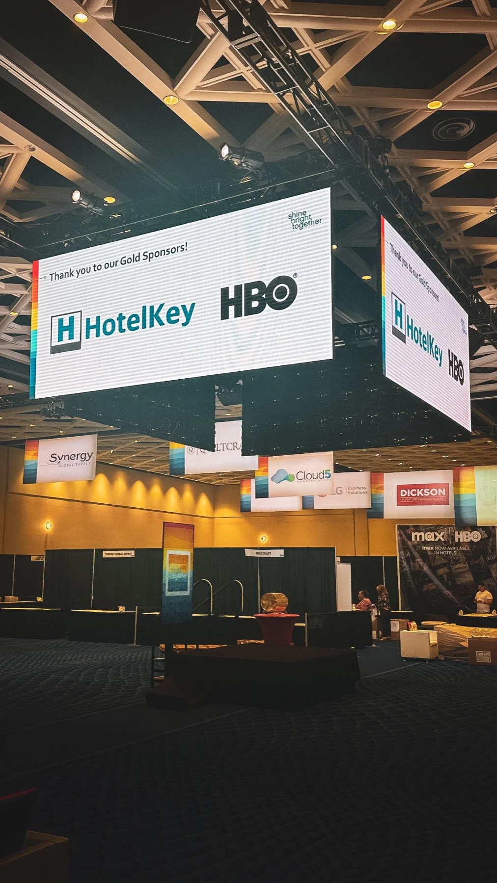 Hanging LED sponsor cube above a trade show floor